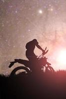 motocross driver silhouette in the evening photo