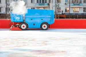 An ice cleaning machine polishes the ice rink at the stadium. photo