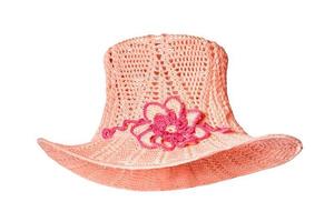 Knitted women's hat with a flower in front in the form of a bowler hat in pink. The image is isolated on a white background. photo