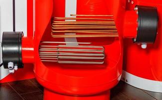 Heating elements in an industrial electric boiler in red. photo