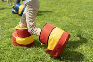 Funny shoes for game. Fun holiday of child in summer. Entertainment on green grass. photo