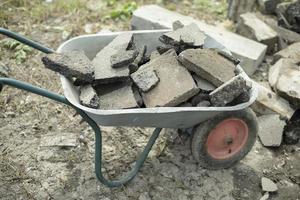 Cart with broken asphalt. Stone cleaning. photo