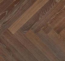Dark wood planks with a vibrant brown texture create a symmetrical herringbone pattern. photo