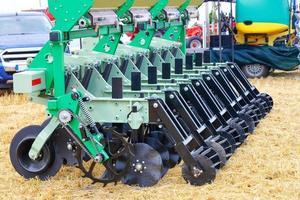 A fragment of a multi-row seeder with knife harrows for field work against the background of yellow stubble. 28.7.21. Kyiv Ukraine photo