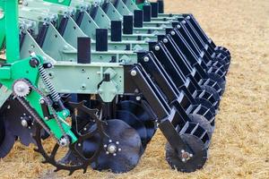 Multi row disc metal cutters and harrows as a hitch for agricultural machinery. photo
