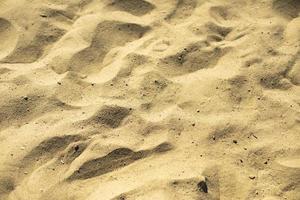 arena amarilla en la playa. textura de arena. fondo de verano. foto