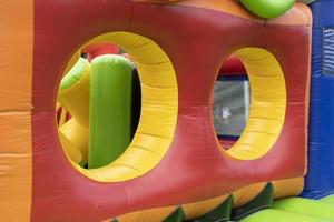 Inflatable construction in amusement park. Obstacle course for children. photo