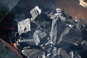 Unlit black coals in a rusty brazier photo