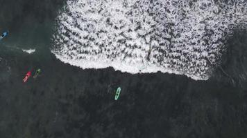 Aerial top down view of enjoy with surfing in the ocean in Bali, Indonesia video