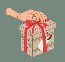 Hands holding Christmas gift in kraft paper with tag and berries. Present box in craft wrapping paper with bow and branches. Colored flat vector illustration isolated on beige background.