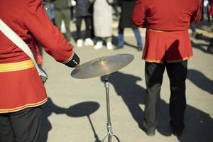 Drummer at parade in red clothes. Drumming. photo