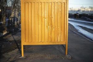 Yellow bus stop. Steel structure by road. photo