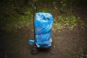 Cart with cargo. Forgotten bag. Blue package. photo