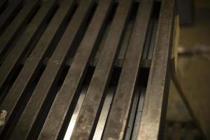 Steel profile lies in row. Metal production. Item in garage. photo