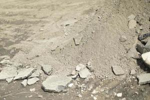 Stones on asphalt. Broken stone on street. Ruined structure. photo