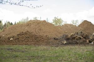 Sand on construction site. Building material is piled up in heap. photo