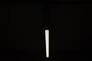 Streak of light in dark. Fluorescent lamp. photo