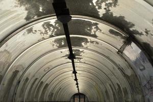 Tunnel made of plastic. Snow on dome. Outgoing perspective. photo
