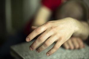 Hand of sleeping person. Guy fell asleep sitting down. photo