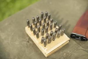 Ammo in board. Cartridges for machine gun. Firearm. photo