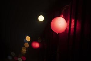 Red ball at construction site. Light on fence. photo