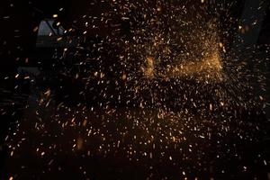 Lights in dark. Sparks from sawing metal. Industrial background. photo