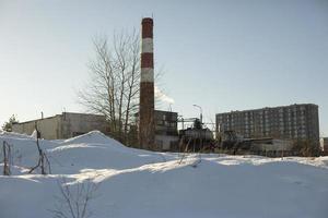 fábrica de tuberías en la ciudad. paisaje industrial. planta en invierno. foto