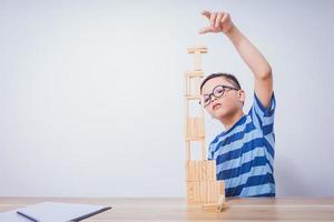 Asian boy playing with a wooden puzzle photo