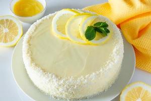 Lemon cake with coconut flakes and white cream, vanilla holiday dessert. photo