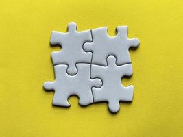 Jigsaw puzzle on yellow background with customizable space for text or ideas. Copy space photo
