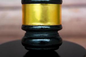 Close up of gavel with blurred wooden background. Copy space and law concept photo