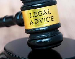 Legal advice text engraved on lawyer gavel with blurred wooden background. Legal and law concept photo