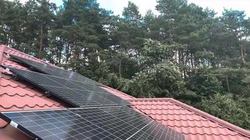 Close up of Solar Panels on Roof of Family House in the Wood, Ecology, nature and energy saving video