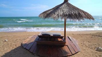 beach chair on beach with sea and blue sky background video