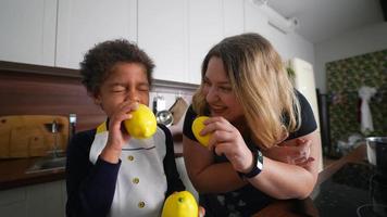 Young girl and adult woman in kitchen tasting lemons video