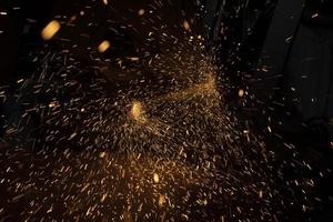 Lot of sparks from cutting steel. Bright lights in space. Industrial background. photo