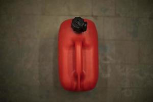 Red canister of fuel. Liquid container. Red plastic. photo