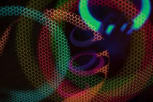 Color music. Abstract background glows in dark. Circles in net. photo