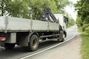 Truck on road. Transportation of goods. Big car on narrow highway. photo