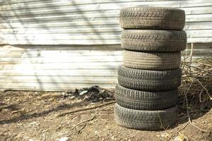 Old wheels are on street. Car tires. photo