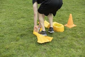 Funny shoes on your feet. Entertainment in park. Yellow flippers on legs. Fun competition. photo