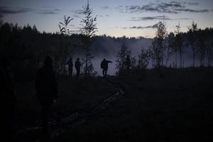 Man in fog before dawn. Rest on lake. photo