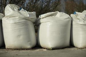 White sandbags. Large bags of material for construction. photo