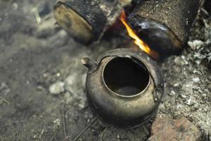 Kettle for tea on fire. Tea in nature. photo