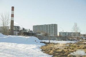 Pipe factory in city. Industrial landscape. Plant in winter. photo