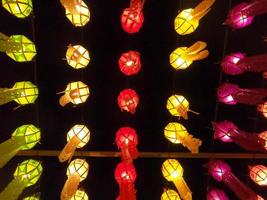 Colorful look up and bottom view of Thai Lanna style lanterns to hang in front of the temple on night time in Loy Kratong Festival. photo