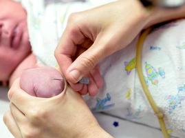 Image of nurse hands uses gradually stabbing medical needles at baby's hands to do a blood test. photo