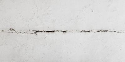 Texture white concrete wall has cracks photo