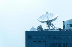 Large satellite dish on rooftop building photo