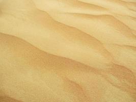 Waves of sand texture. Dunes of the desert. Desert dunes sunset landscape. photo